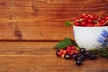 Red and black currants in a white mug on a wooden background Royalty Free Stock Photo