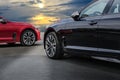 Red and black elegant car under a beautiful sky Royalty Free Stock Photo