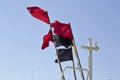 Red and black flags waving in the blue sky in Norre Vorupor Denmark