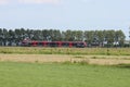 Red and black Flirt train for R-Net on track between Gouda and Alphen aan den Rijn at Waddinxveen