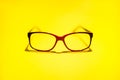 Red black glasses on the yellow background Royalty Free Stock Photo