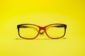 Red black glasses on the yellow background. Royalty Free Stock Photo