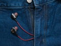 Red with black headphones sticking out of his pants blue jeans Royalty Free Stock Photo