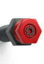 Red and black hexagonal and cylindrical mechanical object, possibly a stylized nut or Royalty Free Stock Photo