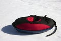 Red and black material snow inner tubing (toobing) on the white Royalty Free Stock Photo