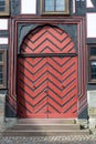 A red and black medieval wooden door