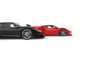 Red and black modern super sport cars - red in the lead - side view