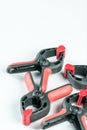 Red and black plastic carpenters pinch tools with copy space over white background