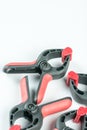 Red and black plastic carpenters pinch tools with copy space