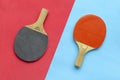 Red and black rackets for table tennis on blue and red background. Ping pong sports equipment in minimal style. Flat lay, top view Royalty Free Stock Photo