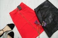 Red and black skirts, shoes and wild flowers. Fashionable concept Royalty Free Stock Photo