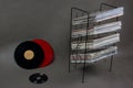 Red and black vinyl record, stand with vinyl records