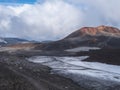 Red and black volcanic Iceland landscape at Fimmvorduhals hiking trail with glacier volcano lava field, snow and magni and mudi Royalty Free Stock Photo