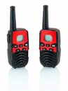 Red and black walkie talkie isolated on white background with shadow reflection. Portable radio transmitter. Royalty Free Stock Photo