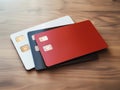 Red, black and white bank credit card on wooden table isolated AI