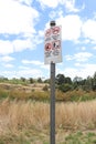 a red, black and white sign of instructions for visitors including Keep Dogs On Lead Royalty Free Stock Photo