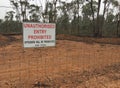 Red, black and white Unauthorised Entry Prohibited, Offenders Will Be Prosecuted sign on the fence of shire council property Royalty Free Stock Photo