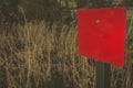 Red blank rectangular sign in the crop field with copy space to