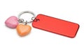 Red blank rectangular tag with heart charms on keychain Royalty Free Stock Photo