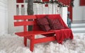 Red blanket and cushions on red bench with white artificial snow outdoors Royalty Free Stock Photo