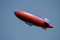 Red blimp in blue sky