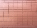 Red block wall pattern close up pipe at bottom Royalty Free Stock Photo