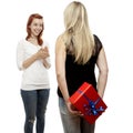 Red and blond haired girls with gift behind back