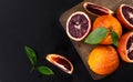 Red blood oranges with cut and green leaves Royalty Free Stock Photo