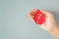 Red blood shape paper cut with white syringe on human`s hand with copy space, blood donation concept Royalty Free Stock Photo