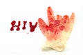 Red bloodshot in glove hand on A word HIV on white background