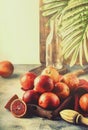 Red bloody oranges for making freshly squeezed juice, gray table background, selective focus, place for text