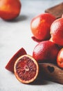 Red bloody oranges for making freshly squeezed juice, gray table background, selective focus, place for text
