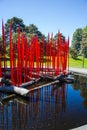 Red Blown Glass Reeds on Reflecting Pool