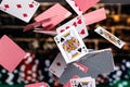 Red and Blue backed Playing cards cascading in front of a background of stacked poker chips