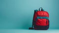 Red and blue backpack against a turquoise background, representing back to school essentials Royalty Free Stock Photo
