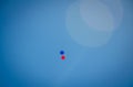 Red and blue balloons in the sky