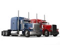 Red and blue big modern semi - trailer trucks - side by side