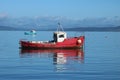 Red and blue boats in Morecambe Bay from shore Royalty Free Stock Photo