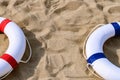 Red & blue buoys on sand with copy space