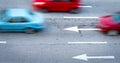 Red and blue car fast moving on asphalt road in the city. Blurred motion of fast speed compact car on asphalt road. Urban Royalty Free Stock Photo