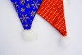 Red and blue Christmas hats on white background