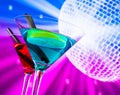 Red and blue cocktail with sparkling disco ball background with space for text Royalty Free Stock Photo