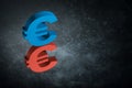 Red and Blue EU Currency Symbol or Sign With Mirror Reflection on Dark Dusty Background