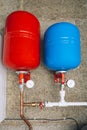 Red and blue expansion tanks in boiler room Royalty Free Stock Photo