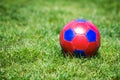 Red and blue fotball on grass
