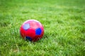 Red and blue fotball on grass