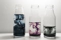Color ink swirling movement in the clear glass three bottles water art abstract Royalty Free Stock Photo