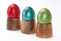 Red, blue and green easter eggs in wooden holders Royalty Free Stock Photo
