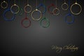 Red, blue, green and gold christmas balls with strings on black background. Holiday greeting card with merry christmas sign Royalty Free Stock Photo