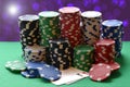 Red, blue, green, white and black poker chips pile and aces Royalty Free Stock Photo